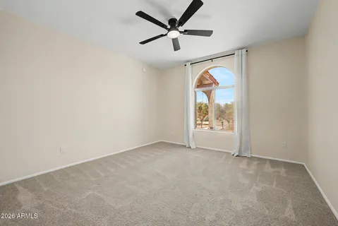 a view of empty room with wooden cabinet and refrigerator