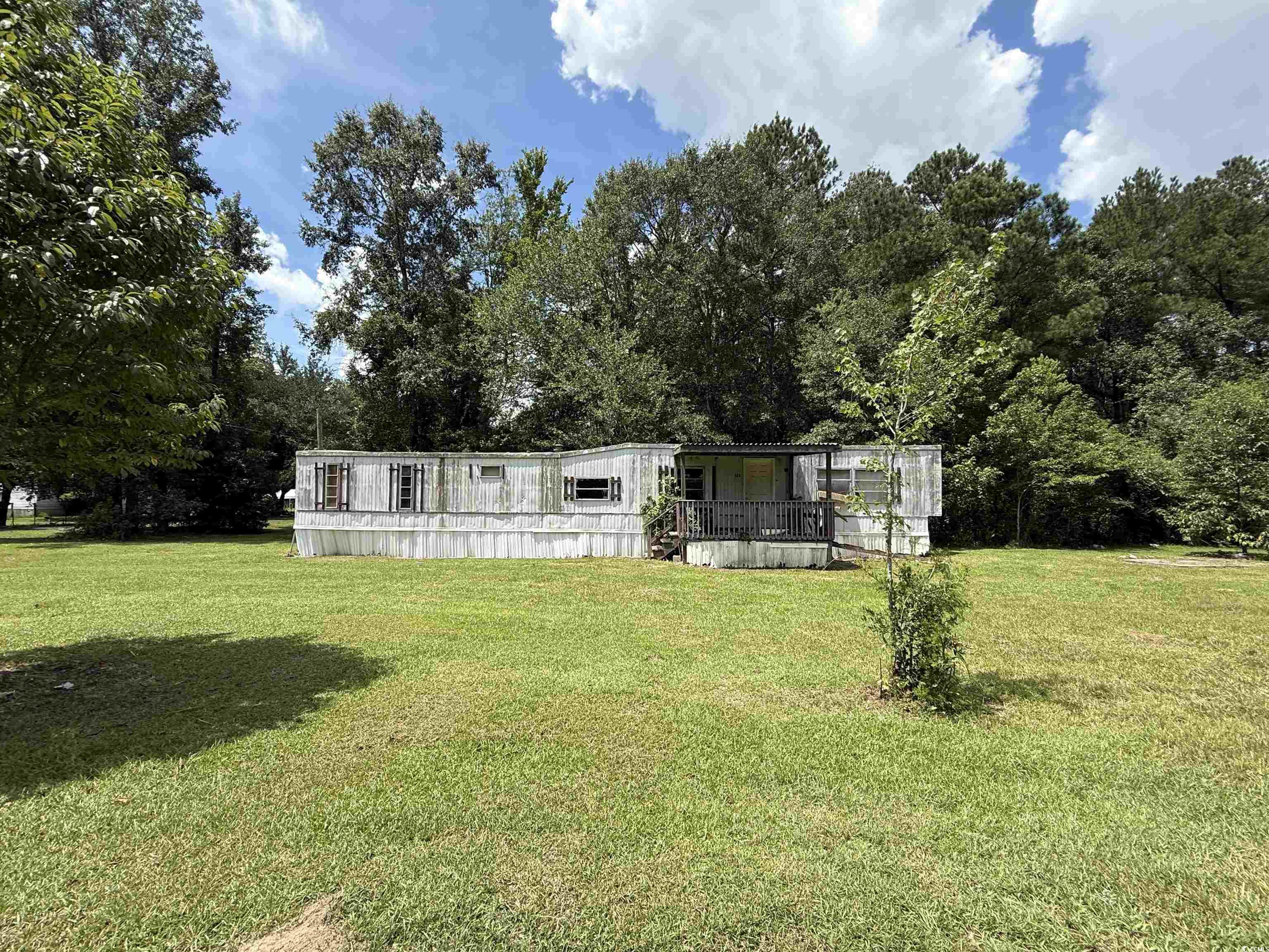 Tbd Morrisville Road Andrews, SC 29510 - Photo 11 of 29 Manufactured / mobile home featuring a wooden deck, a front yard, and view of wooded area