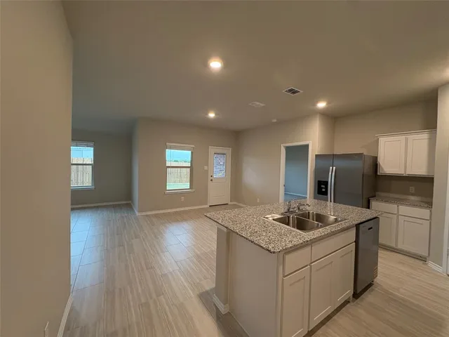 a kitchen with a sink stove and refrigerator