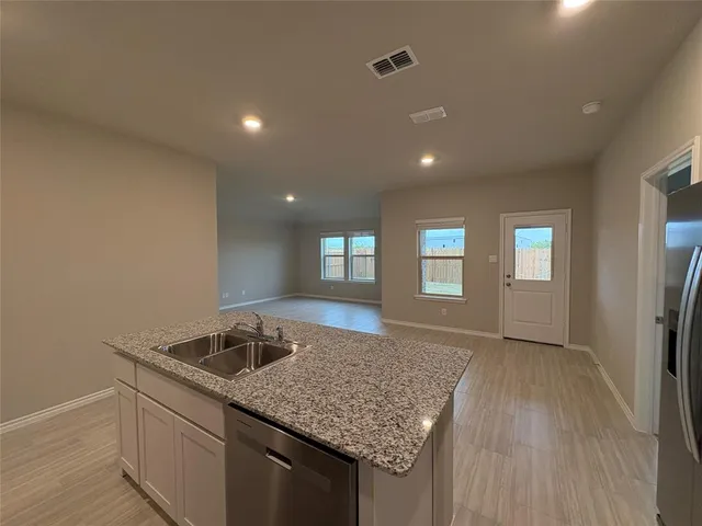 a kitchen with a sink stove and refrigerator