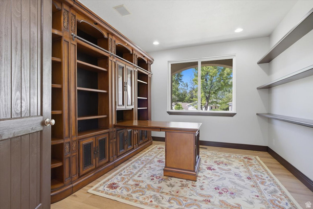 12317 Cypress Point Way Draper, UT 84020 - Photo 12 of 41 Custom built-in cabinetry with integrated desk and glass-front storage, recessed lighting, and wood-finish flooring