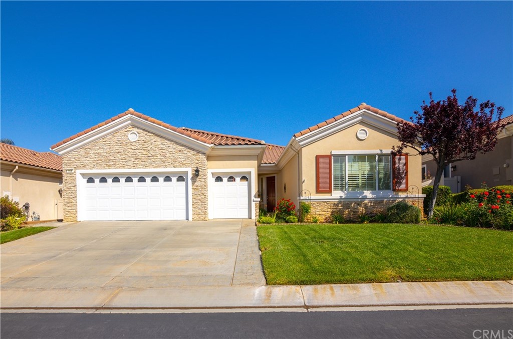 956 Gleneagles Road Beaumont, CA 92223 - Photo 1 of 1 a front view of a house with a yard and garage