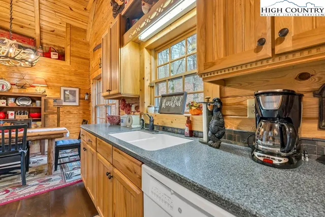 a view of a kitchen with a sink and cabinets
