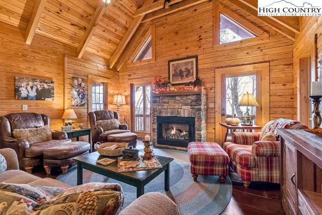 a living room with furniture a fireplace and a table