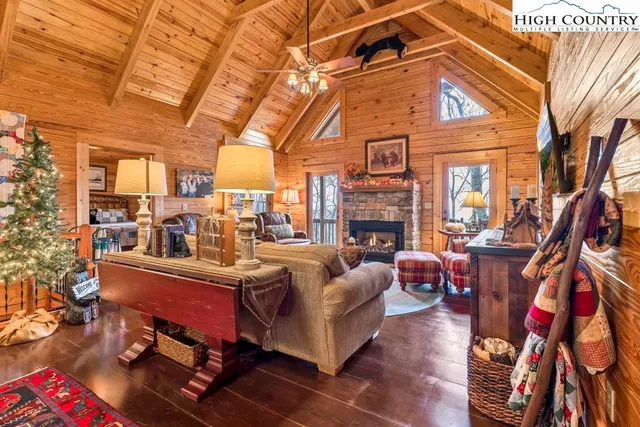 a view of a living room with furniture and a fireplace