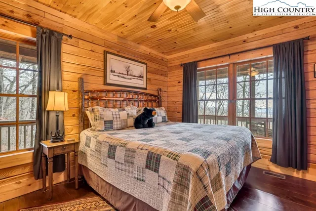 a bedroom with a bed next to a window