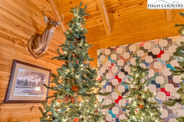 a living room with furniture a fireplace and floor to ceiling windows