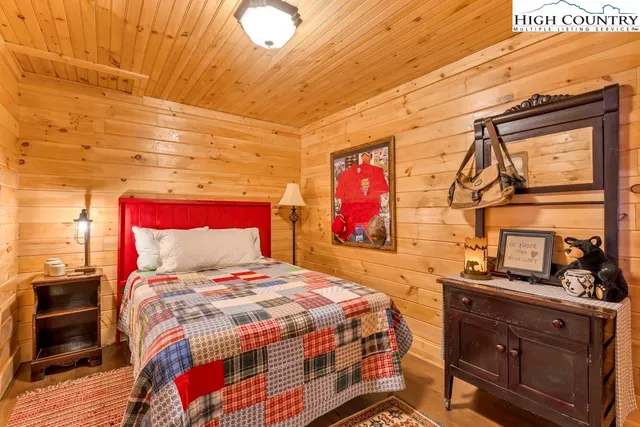 a bed sitting in a bedroom next to a window