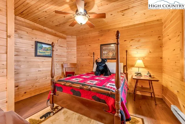 a view of a porch with wooden floor and furniture
