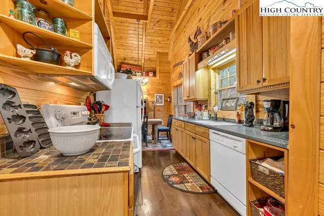 a kitchen with a sink and wooden floor