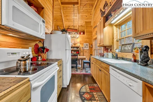 a kitchen with lots of counter top space and wooden floor