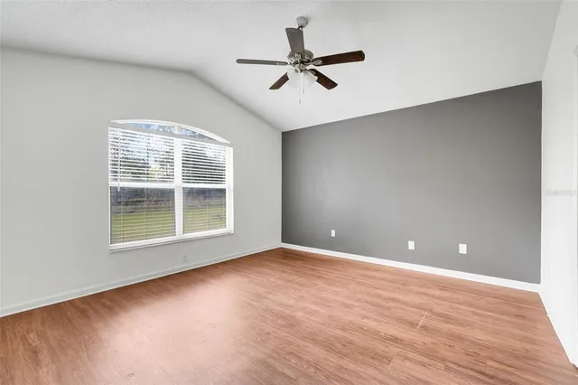 a view of a livingroom with a ceiling fan and wooden floor