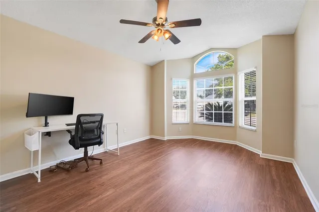a view of a workspace with furniture and a window