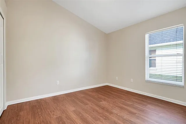 wooden floor in an empty room with a window