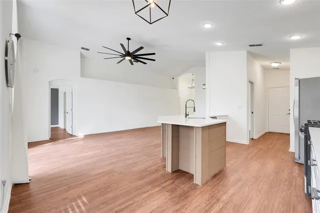 a view of a kitchen with a sink and a refrigerator