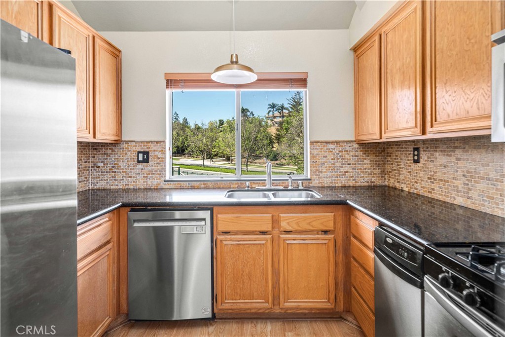 498 Shelburne Lane, Unit B Simi Valley, CA 93065 - Photo 17 of 47 a kitchen with stainless steel appliances granite countertop a stove and a sink