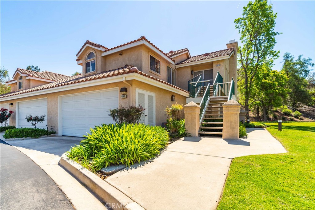 498 Shelburne Lane, Unit B Simi Valley, CA 93065 - Photo 2 of 47 front view of a house with a yard