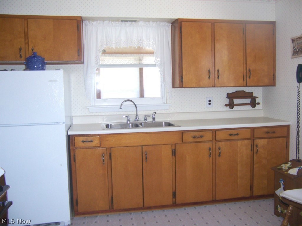 1860 Sandgate Road Madison, OH 44057 - Photo 7 of 13 Kitchen with Appliances , Utility Rm with washer & dryer and leads to Bonus Room