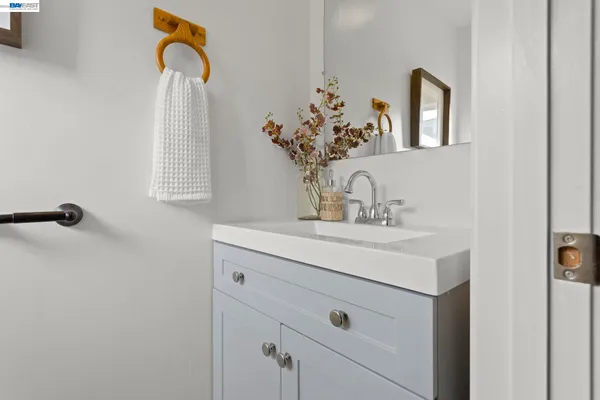 a bathroom with a sink vanity and mirror
