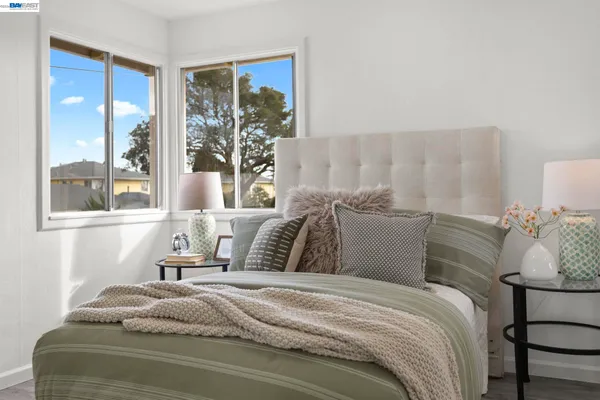 a bedroom with a large bed and a window