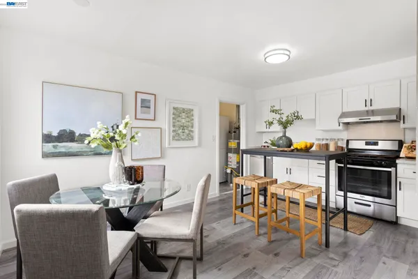 a dining room with furniture and wooden floor