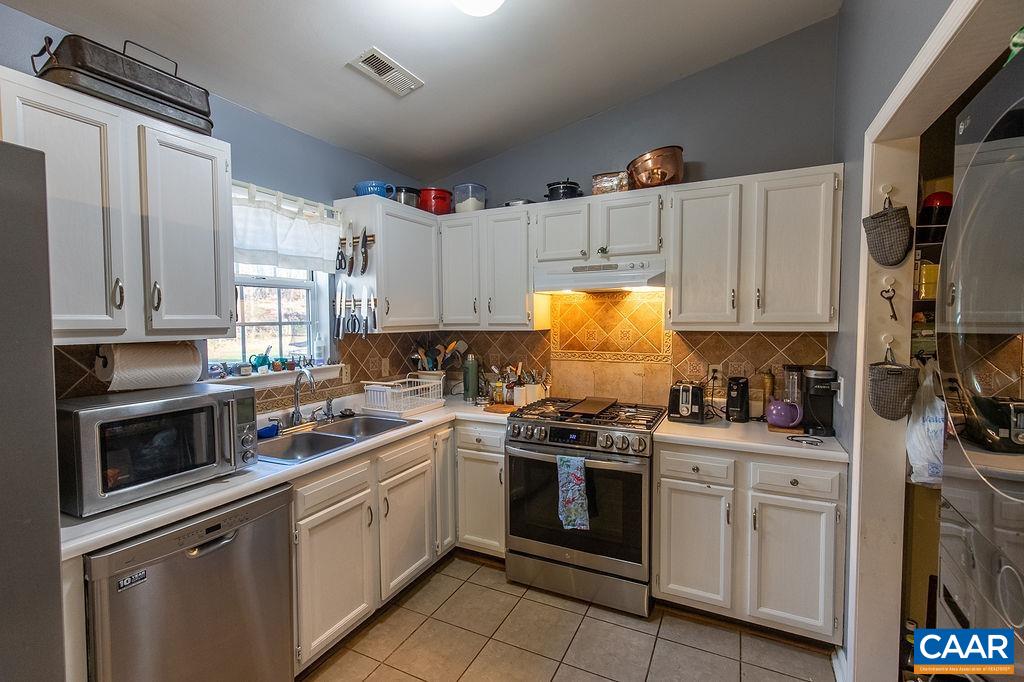 142 Rucker Drive Ruckersville, VA 22968 - Photo 8 of 19 a kitchen with white cabinets and white appliances