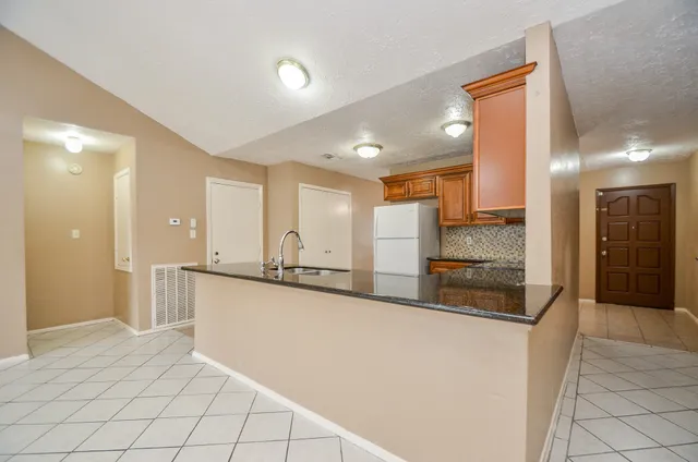 a kitchen with stainless steel appliances a refrigerator and a stove