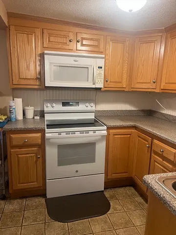 a kitchen with a stove and cabinets