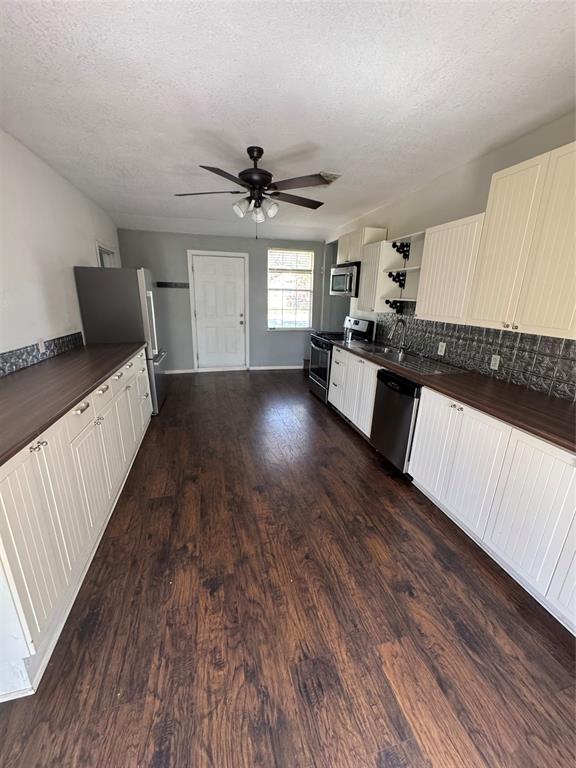 629 Harrison Lane Hurst, TX 76053 - Photo 11 of 20 a large living room with a bed furniture and a wooden floor