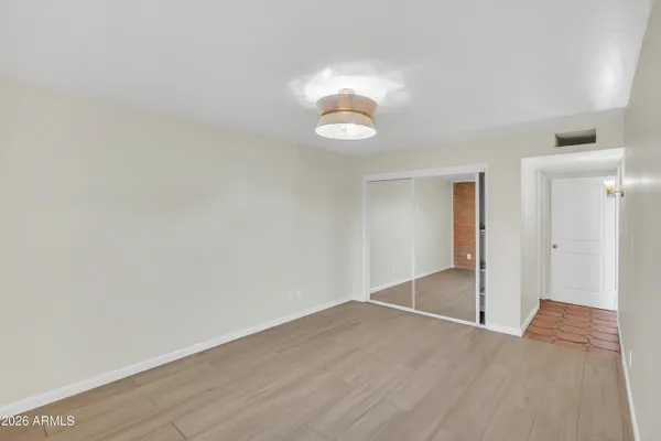 a view of an empty room and wooden floor