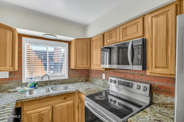 a kitchen with a stove a sink and a cabinets