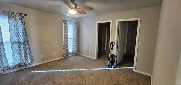 a bathroom with a granite countertop sink a toilet and shower