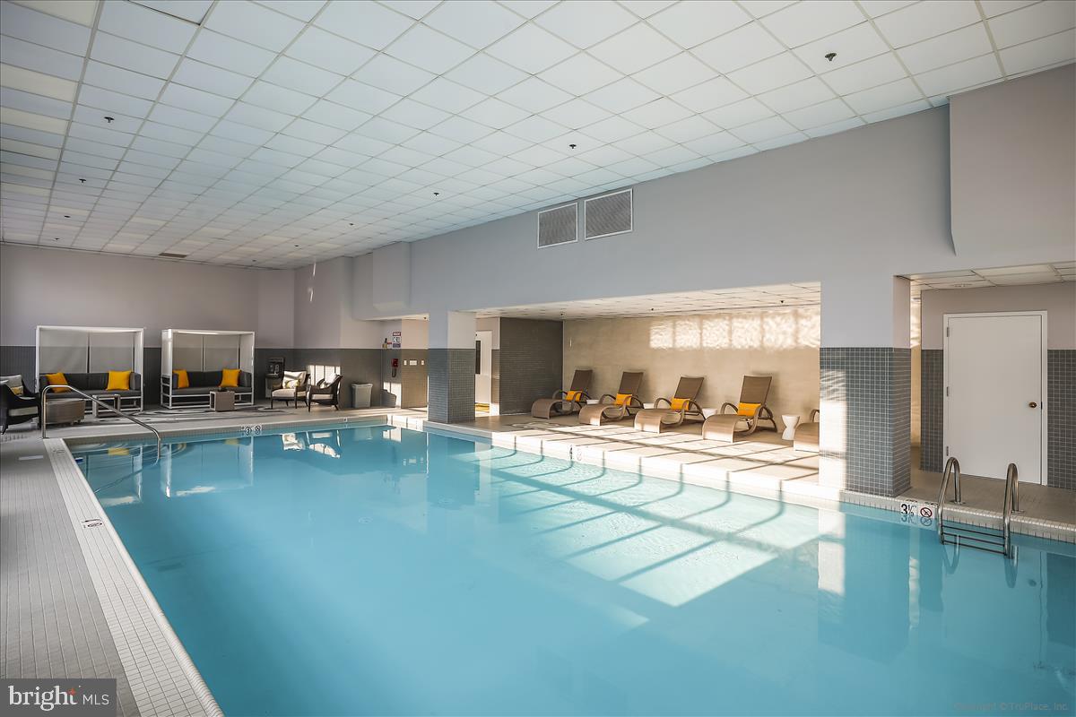 250 President Street, Unit 603 Baltimore, MD 21202 - Photo 13 of 40 a living room with dining table furniture and a wooden floor