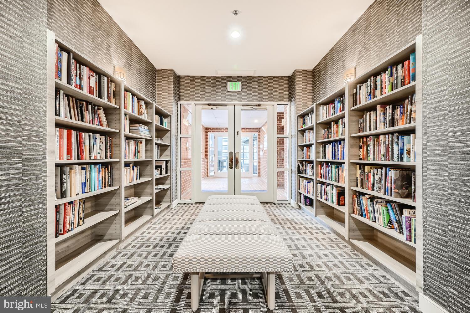 250 President Street, Unit 603 Baltimore, MD 21202 - Photo 29 of 40 a living room with a book shelf and a book shelf