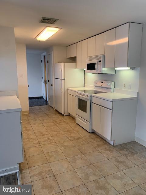 250 President Street, Unit 603 Baltimore, MD 21202 - Photo 5 of 40 a kitchen with stainless steel appliances cabinets a sink and a counter top space