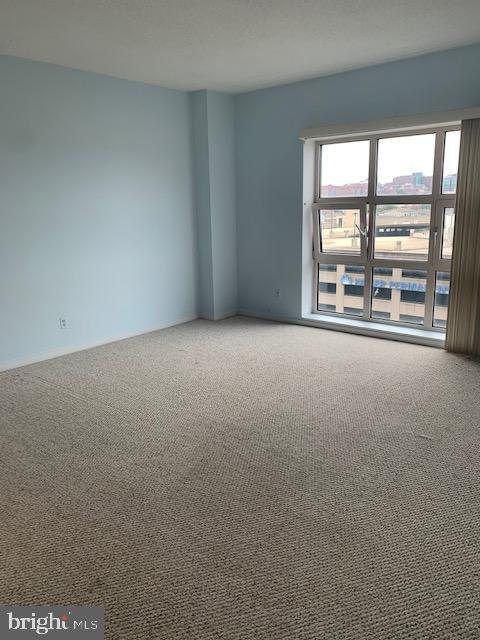 250 President Street, Unit 603 Baltimore, MD 21202 - Photo 7 of 40 an empty room with a windows and city view