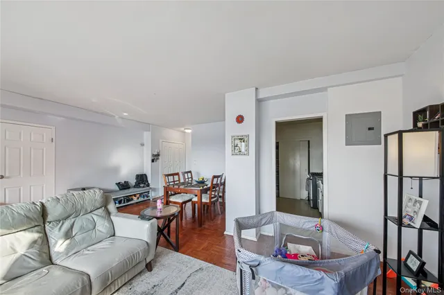 a living room with furniture a refrigerator and a dining table
