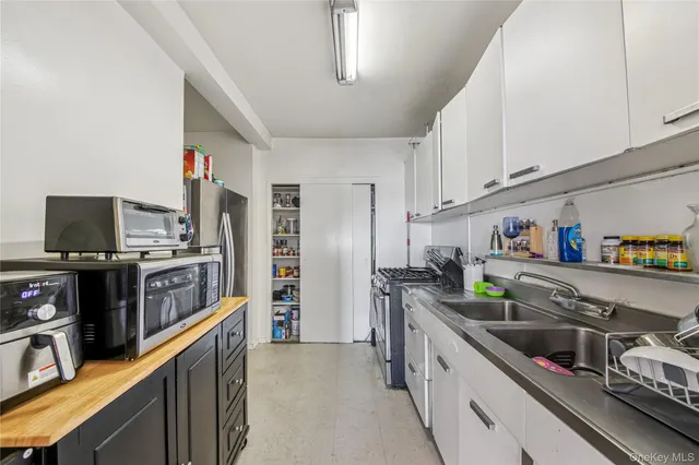a kitchen with stainless steel appliances a stove a sink and a refrigerator