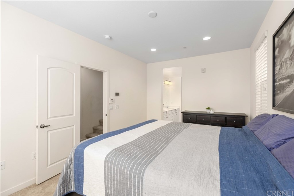 4951 Ash Avenue, Unit E Montclair, CA 91763 - Photo 22 of 41 a bedroom with a bed and a potted plant