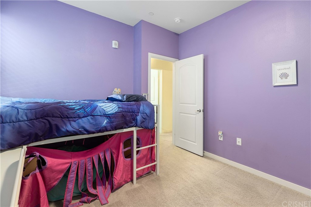 4951 Ash Avenue, Unit E Montclair, CA 91763 - Photo 29 of 41 a bed room with a bed and a couch