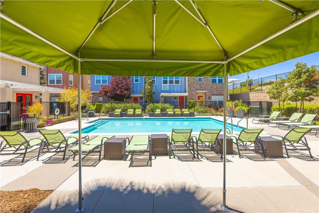 4951 Ash Avenue, Unit E Montclair, CA 91763 - Photo 34 of 41 a patio with a table and chairs under an umbrella