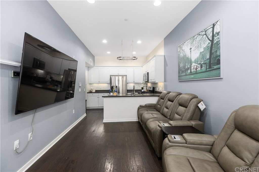 4951 Ash Avenue, Unit E Montclair, CA 91763 - Photo 9 of 41 a living room with furniture and a flat screen tv