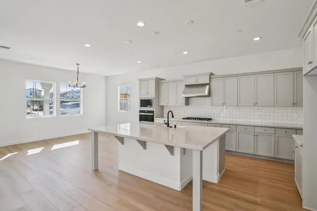a kitchen with stainless steel appliances granite countertop a sink and cabinets