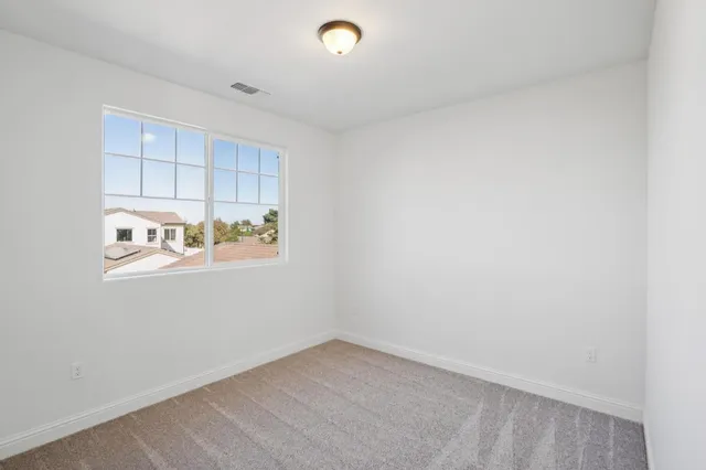 a view of a kitchen with refrigerator and window