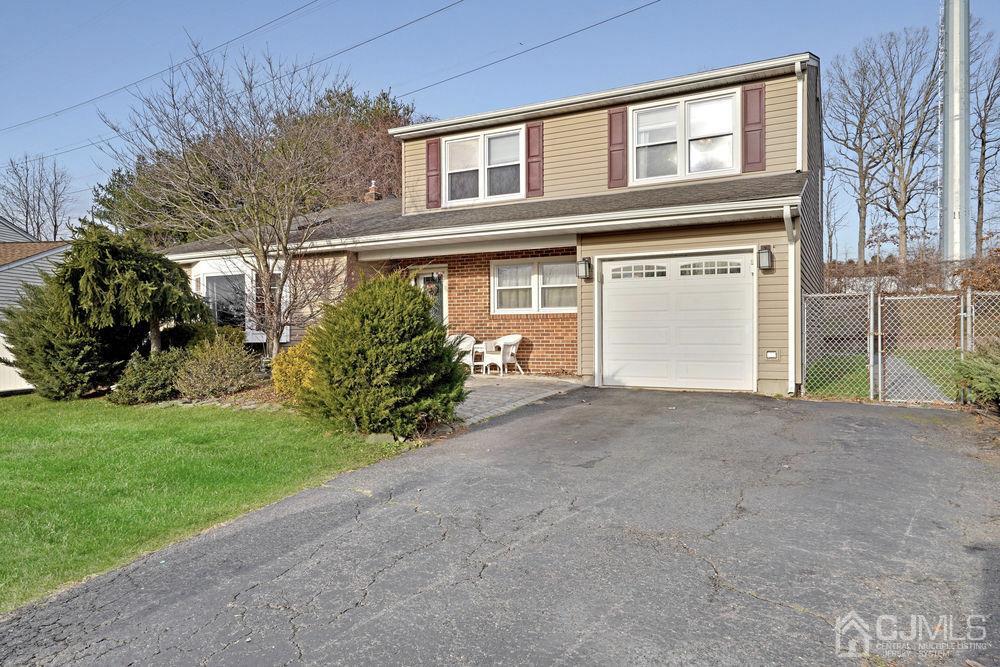 46 Brookside Road Edison, NJ 08817 - Photo 1 of 38 a front view of a house with a yard and garage