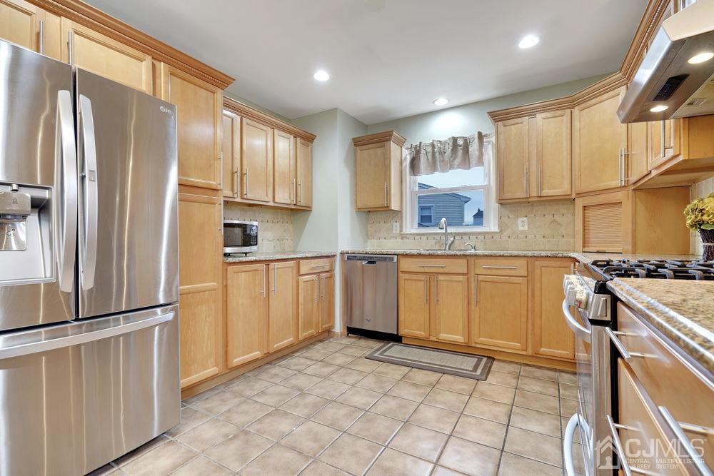 46 Brookside Road Edison, NJ 08817 - Photo 13 of 38 a kitchen with stainless steel appliances granite countertop a refrigerator sink and stove