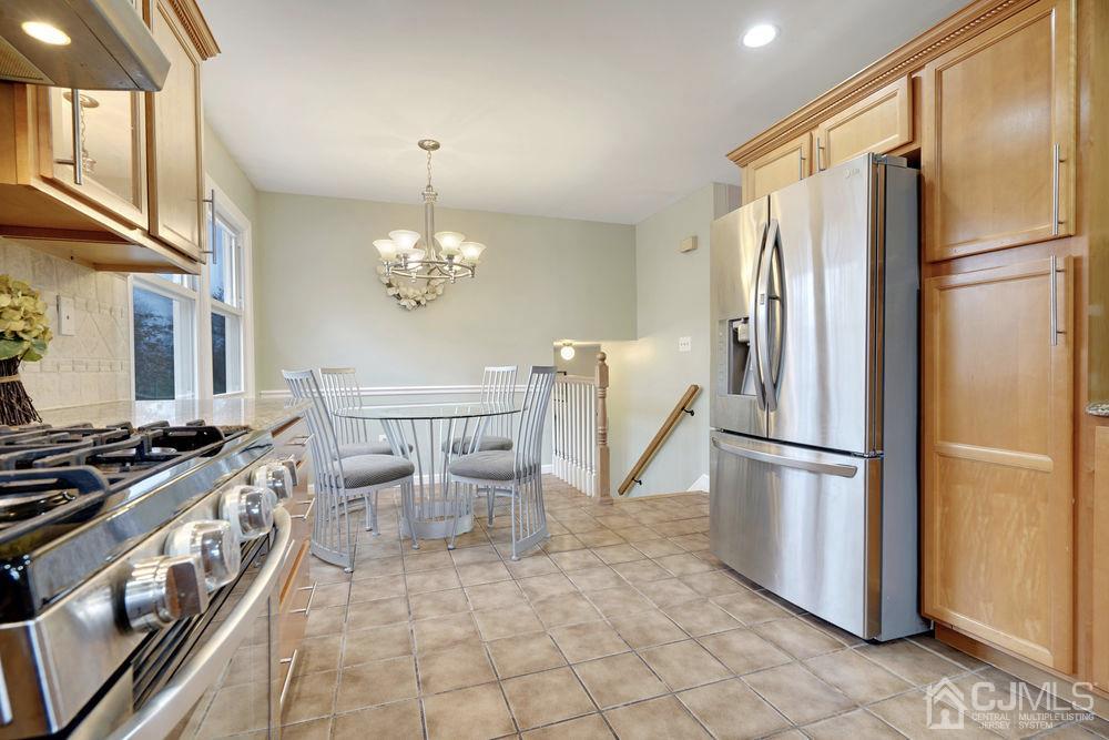 46 Brookside Road Edison, NJ 08817 - Photo 15 of 38 a kitchen with stainless steel appliances a refrigerator stove and sink