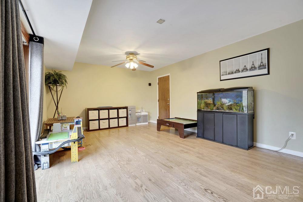 46 Brookside Road Edison, NJ 08817 - Photo 17 of 38 a view of a livingroom with furniture and a flat screen tv