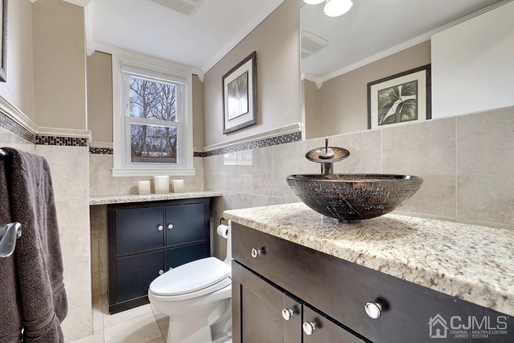 46 Brookside Road Edison, NJ 08817 - Photo 20 of 38 a bathroom with a granite countertop toilet sink and mirror