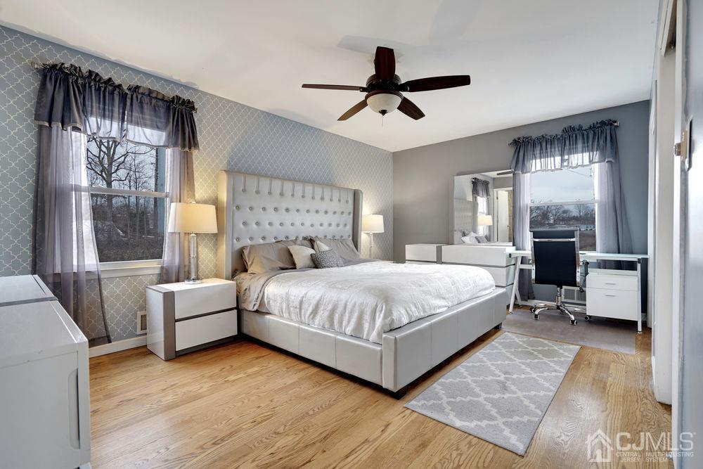 46 Brookside Road Edison, NJ 08817 - Photo 21 of 38 a bedroom with a large bed and a chandelier